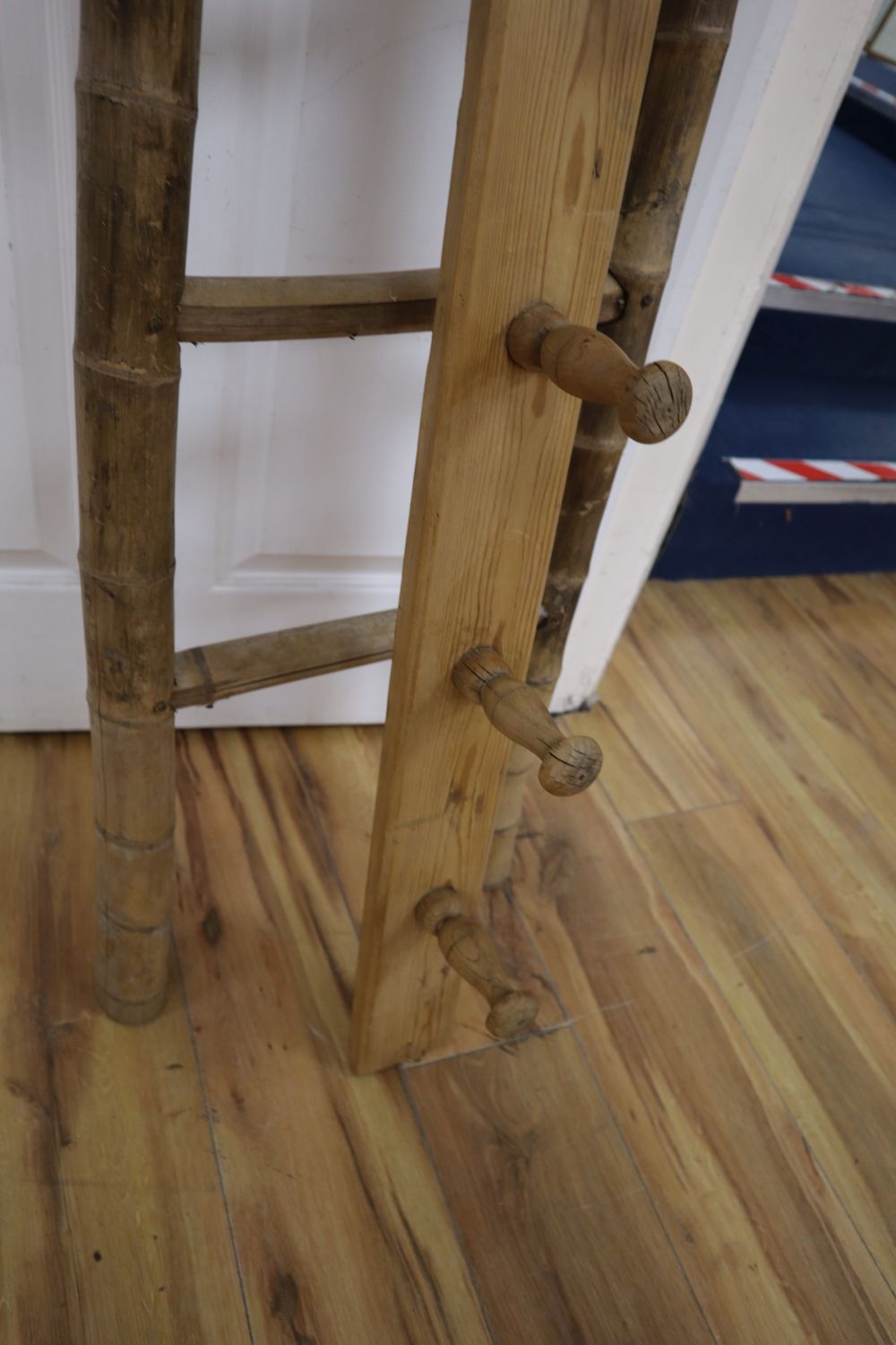 An unusual tapering bamboo seven tread step ladder, 6ft 6in., and a pine wall hanging coat rack